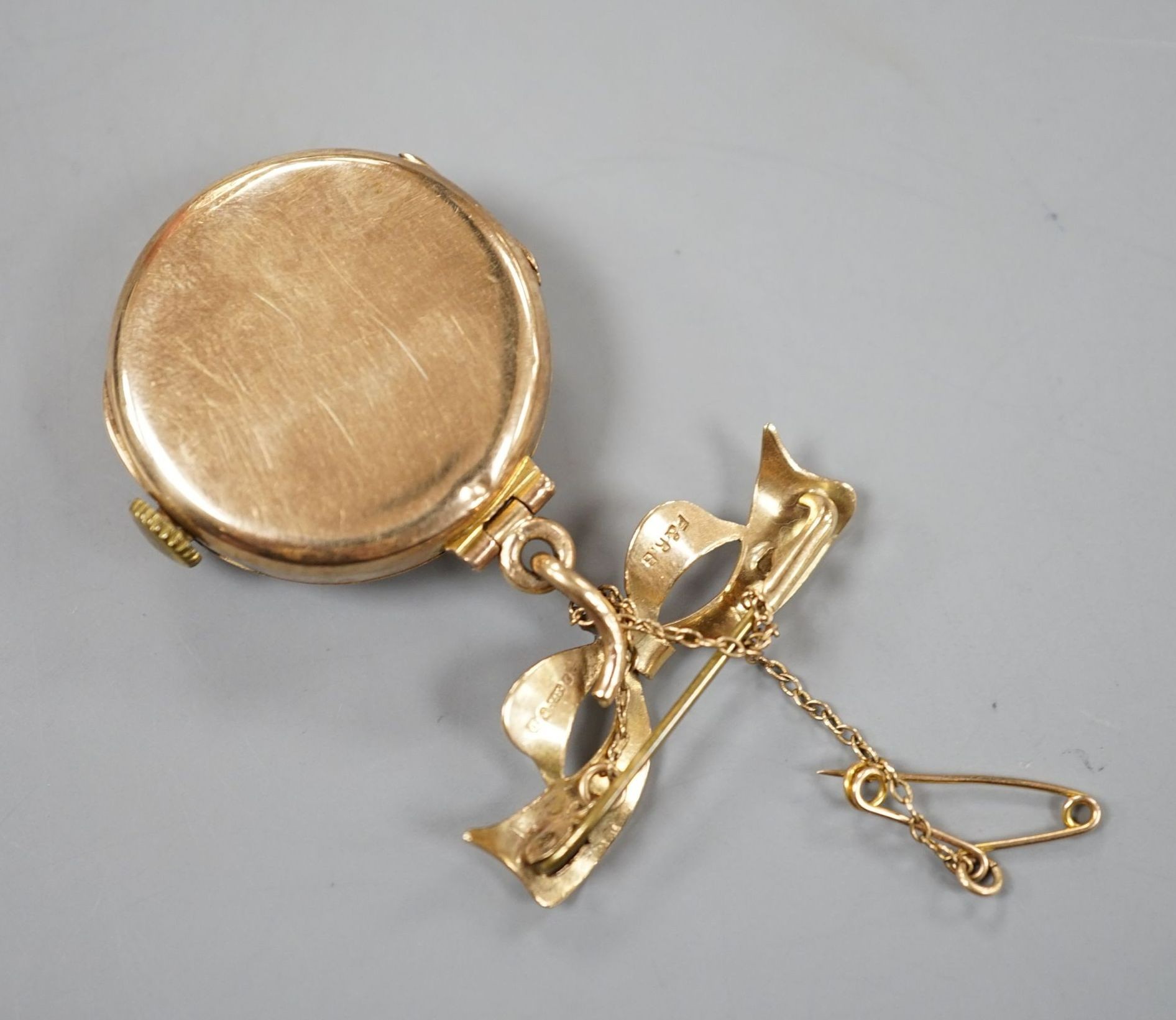 A lady's 9ct 'Dreadnought' fob watch, on a 9ct gold suspension brooch, gross weight 18.5 grams.